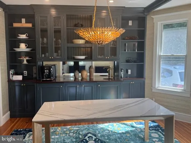 a kitchen with stainless steel appliances a table chairs and a large window