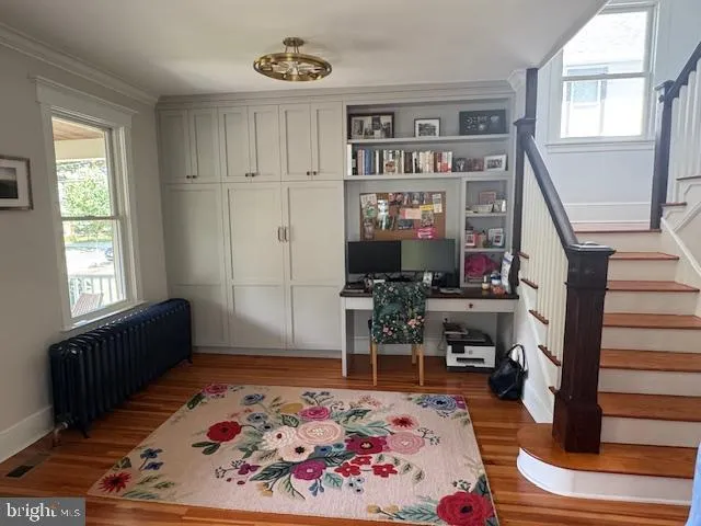 a living room with furniture piano and a window
