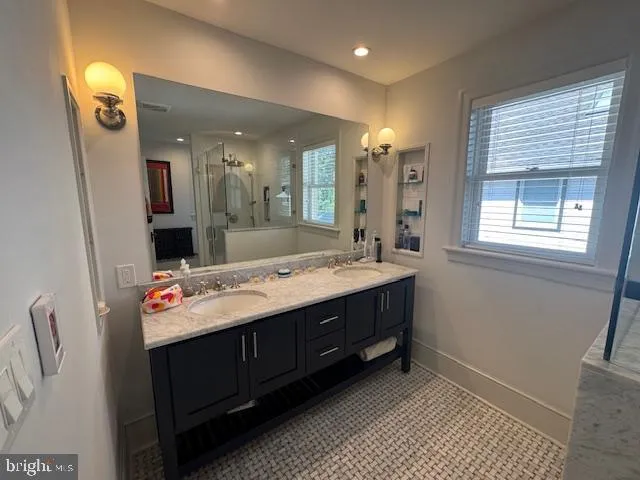 a bathroom with a sink vanity and mirror