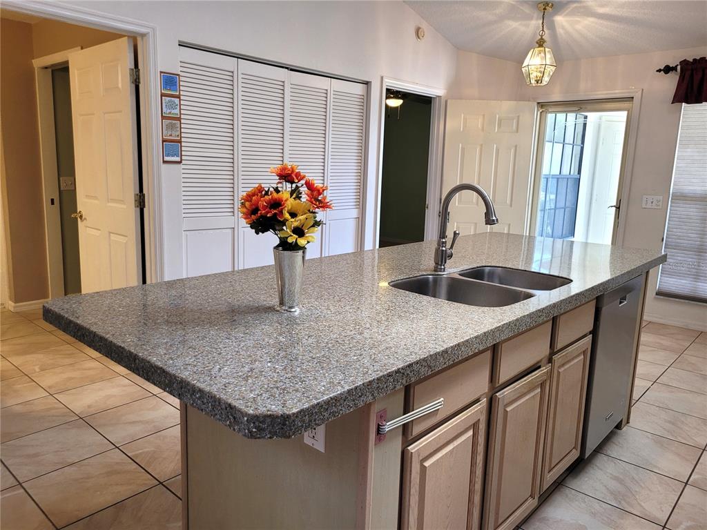 432 Baytree Boulevard Tavares, FL 32778 - Photo 11 of 65 a kitchen with stainless steel appliances granite countertop a sink and a counter space