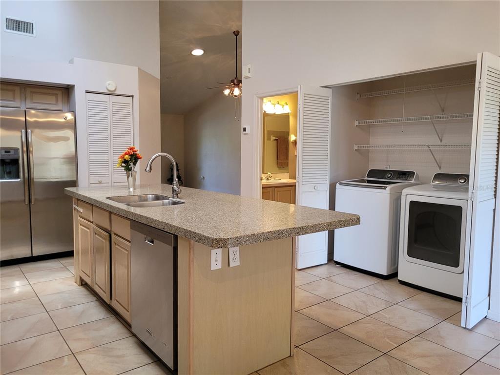 432 Baytree Boulevard Tavares, FL 32778 - Photo 12 of 65 a kitchen with stainless steel appliances granite countertop a sink and a stove
