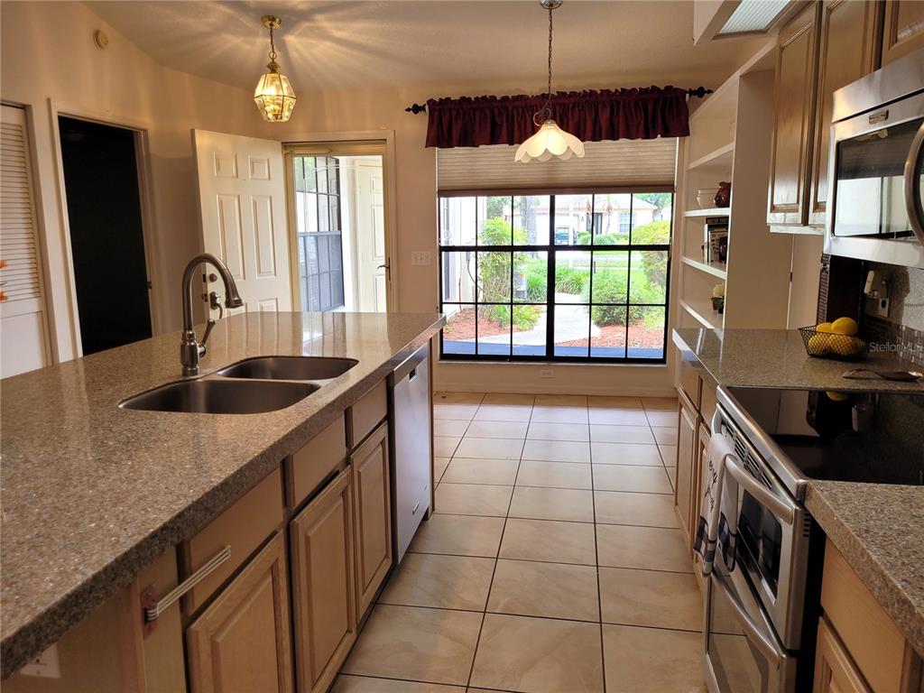 432 Baytree Boulevard Tavares, FL 32778 - Photo 15 of 65 a kitchen with a sink a window and cabinets