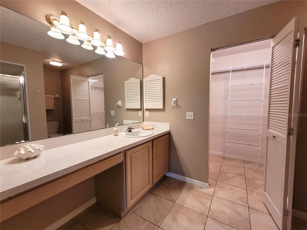 432 Baytree Boulevard Tavares, FL 32778 - Photo 22 of 65 a bathroom with a double vanity sink and a mirror