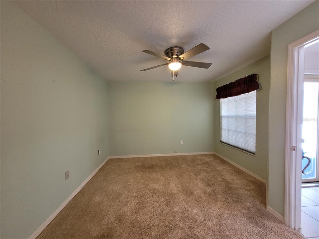 432 Baytree Boulevard Tavares, FL 32778 - Photo 26 of 65 an empty room with windows and ceiling fan