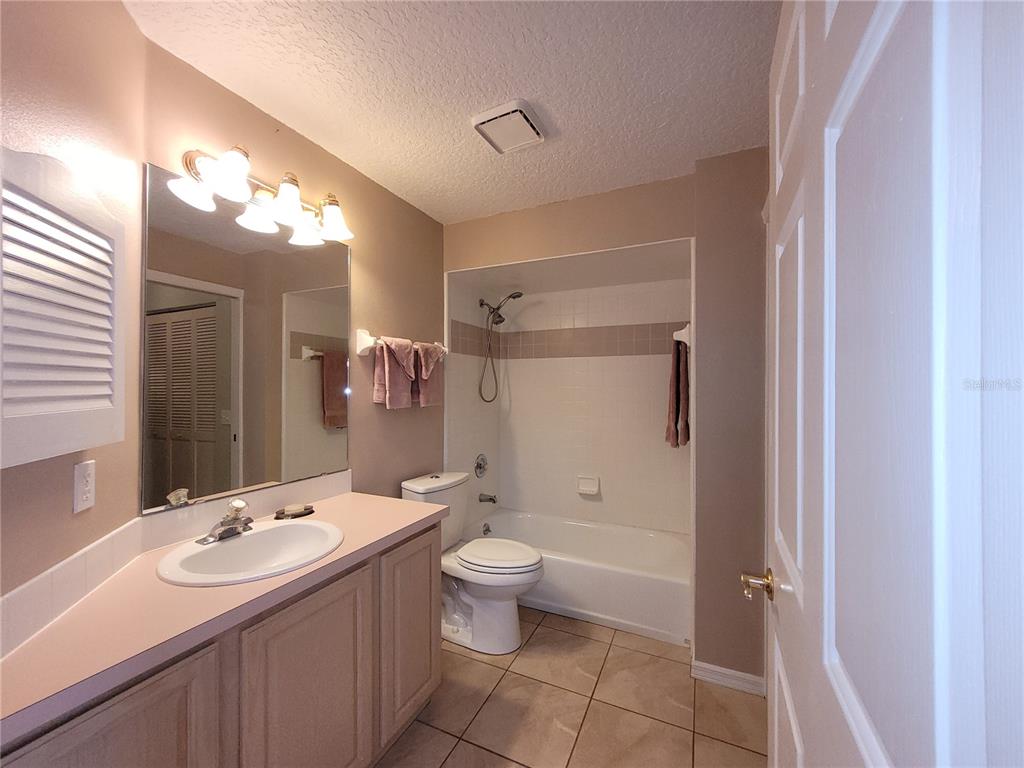 432 Baytree Boulevard Tavares, FL 32778 - Photo 30 of 65 a bathroom with a sink toilet mirror and shower