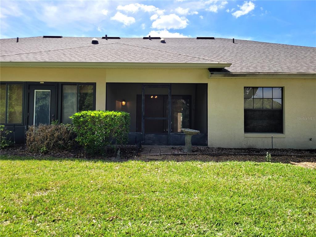 432 Baytree Boulevard Tavares, FL 32778 - Photo 34 of 65 a view of a house with a small yard and a large window