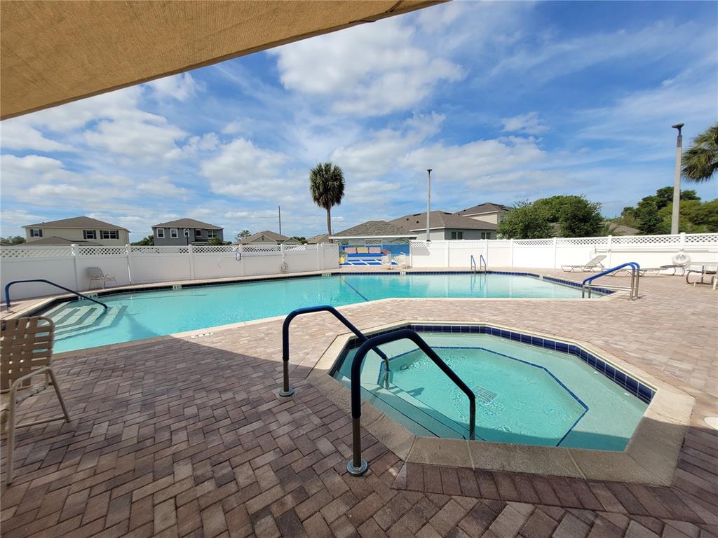 432 Baytree Boulevard Tavares, FL 32778 - Photo 47 of 65 a view of a swimming pool with a yard and a chair