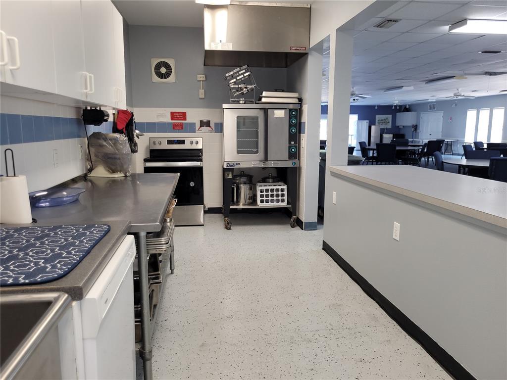 432 Baytree Boulevard Tavares, FL 32778 - Photo 60 of 65 a kitchen with stainless steel appliances granite countertop a stove and a refrigerator