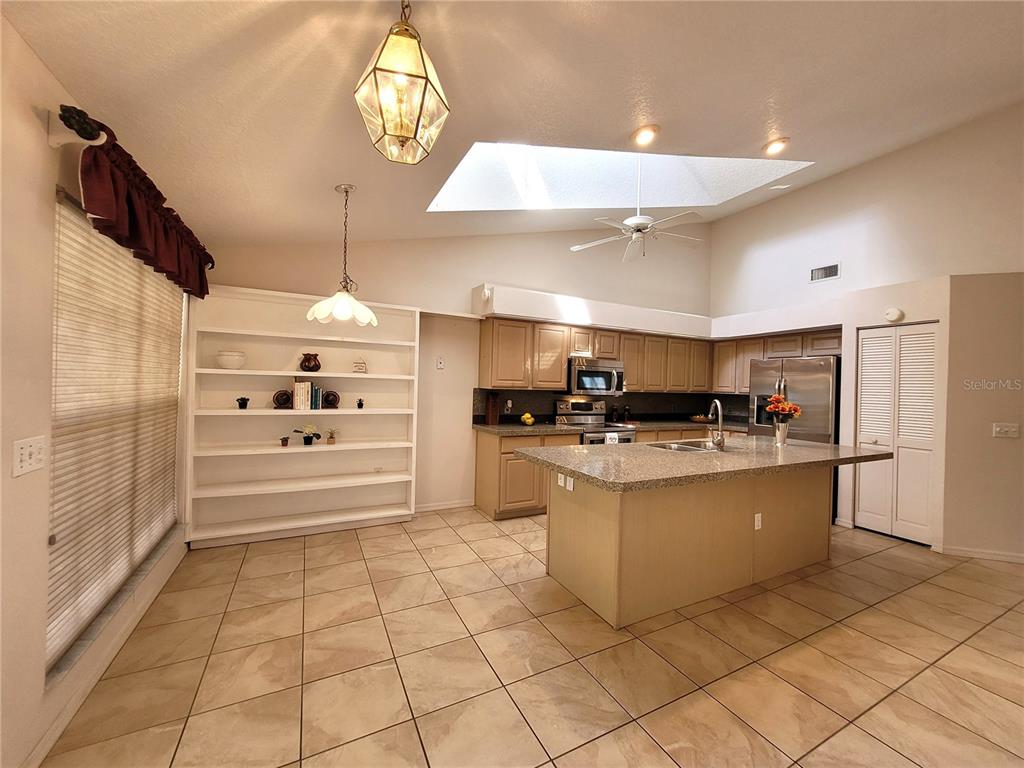 432 Baytree Boulevard Tavares, FL 32778 - Photo 7 of 65 a large kitchen with cabinets