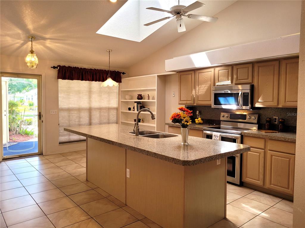 432 Baytree Boulevard Tavares, FL 32778 - Photo 8 of 65 a kitchen with a sink cabinets and window