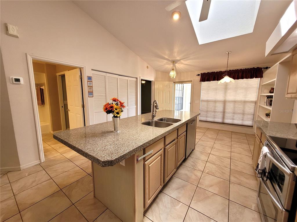432 Baytree Boulevard Tavares, FL 32778 - Photo 9 of 65 a kitchen with stainless steel appliances granite countertop a sink and cabinets