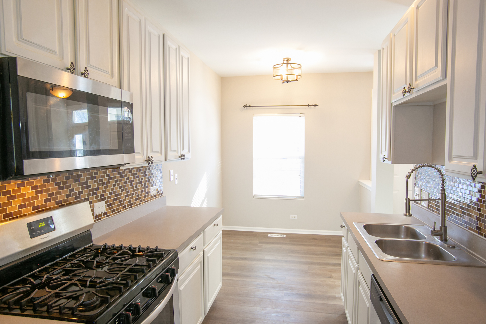 848 County Line Road Aurora, IL 60502 - Photo 6 of 20 a kitchen with granite countertop a stove and a sink
