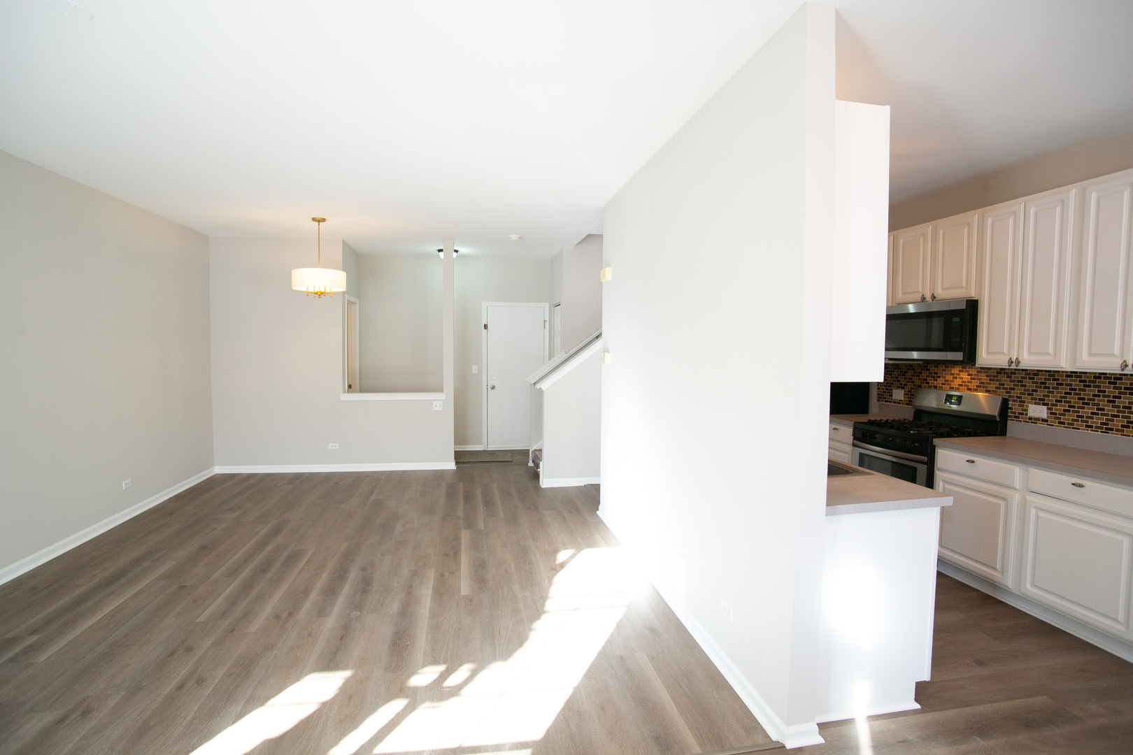 848 County Line Road Aurora, IL 60502 - Photo 8 of 20 a view of a kitchen with a sink wooden floor and a refrigerator
