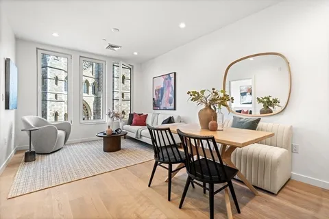 a view of a dining room with furniture window and wooden floor