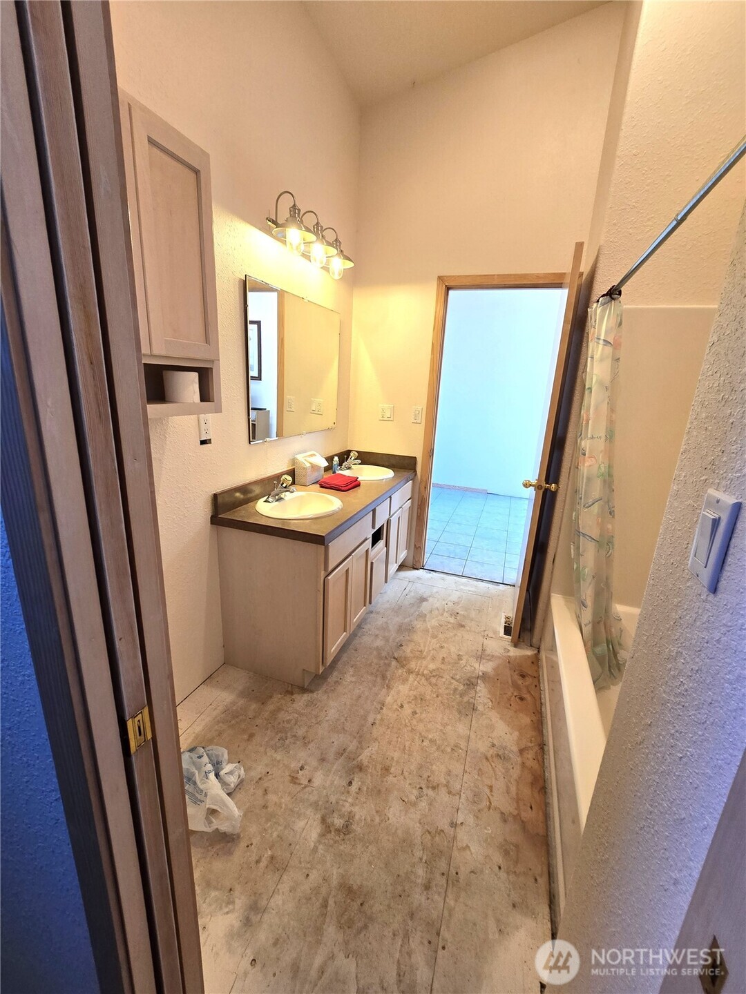 30100 H Street Ocean Park, WA 98640 - Photo 8 of 22 a bathroom with sink a mirror a vanity and a shower