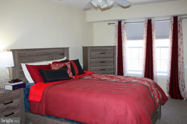 a large bed sitting in a bedroom next to a window