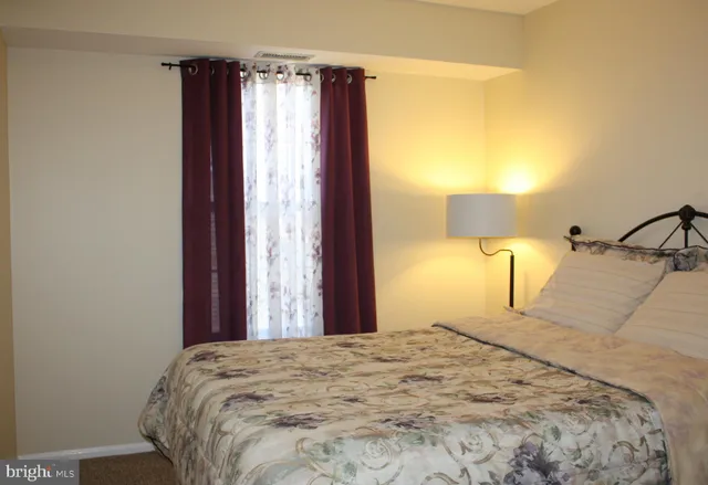 a bedroom with a bed and a lamp