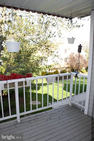 a view of a balcony with wooden floor