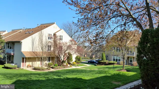 a view of a house with a tree in front