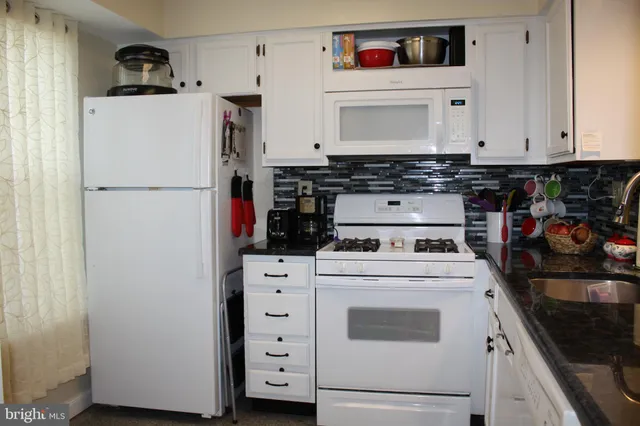 a white refrigerator freezer sitting inside of a kitchen