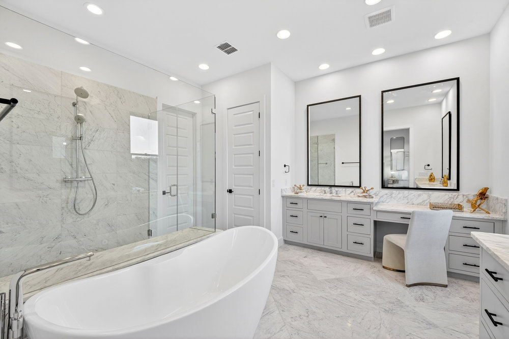 2707 Salek View Austin, TX 78741 - Photo 22 of 39 Bathroom with vanity, a freestanding tub, a marble finish shower, light marble finish floors, and recessed lighting