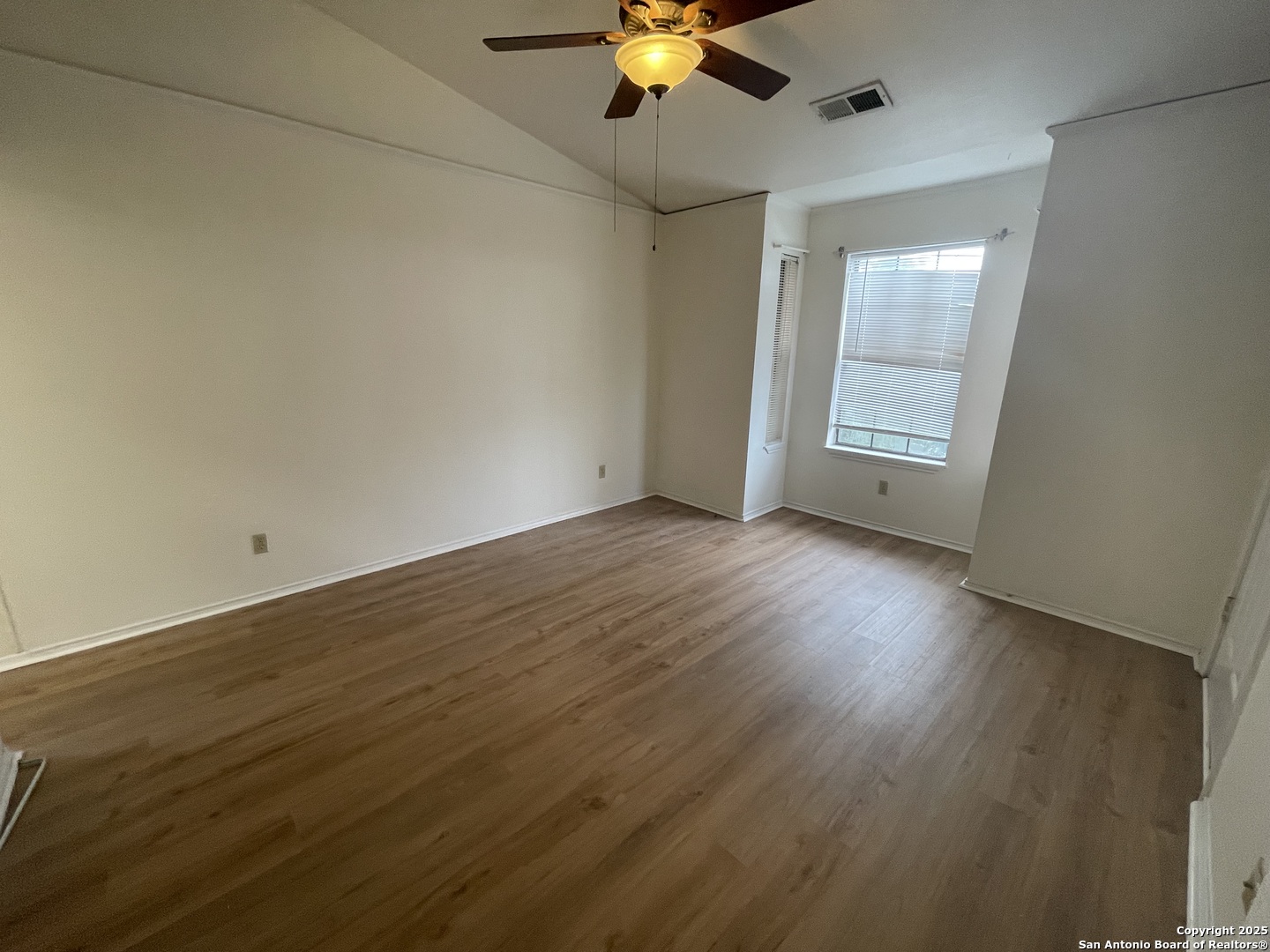wooden floor in an empty room with a window