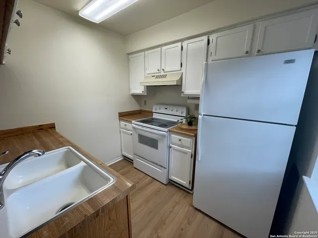 a kitchen with a refrigerator and a sink