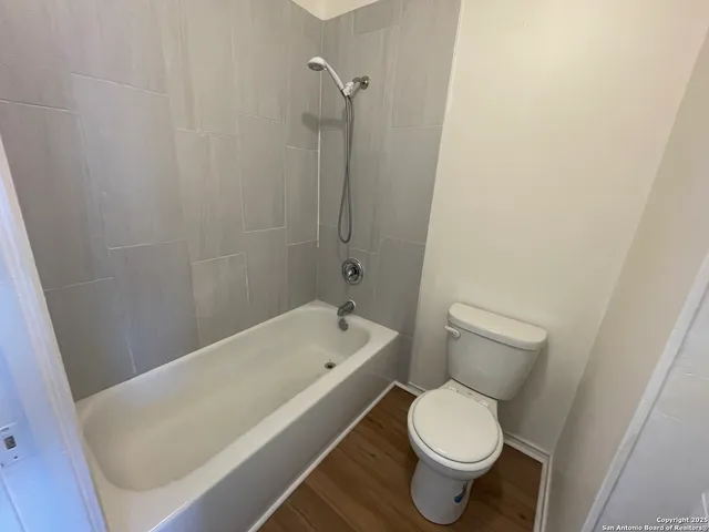 a bathroom with a toilet and a bathtub