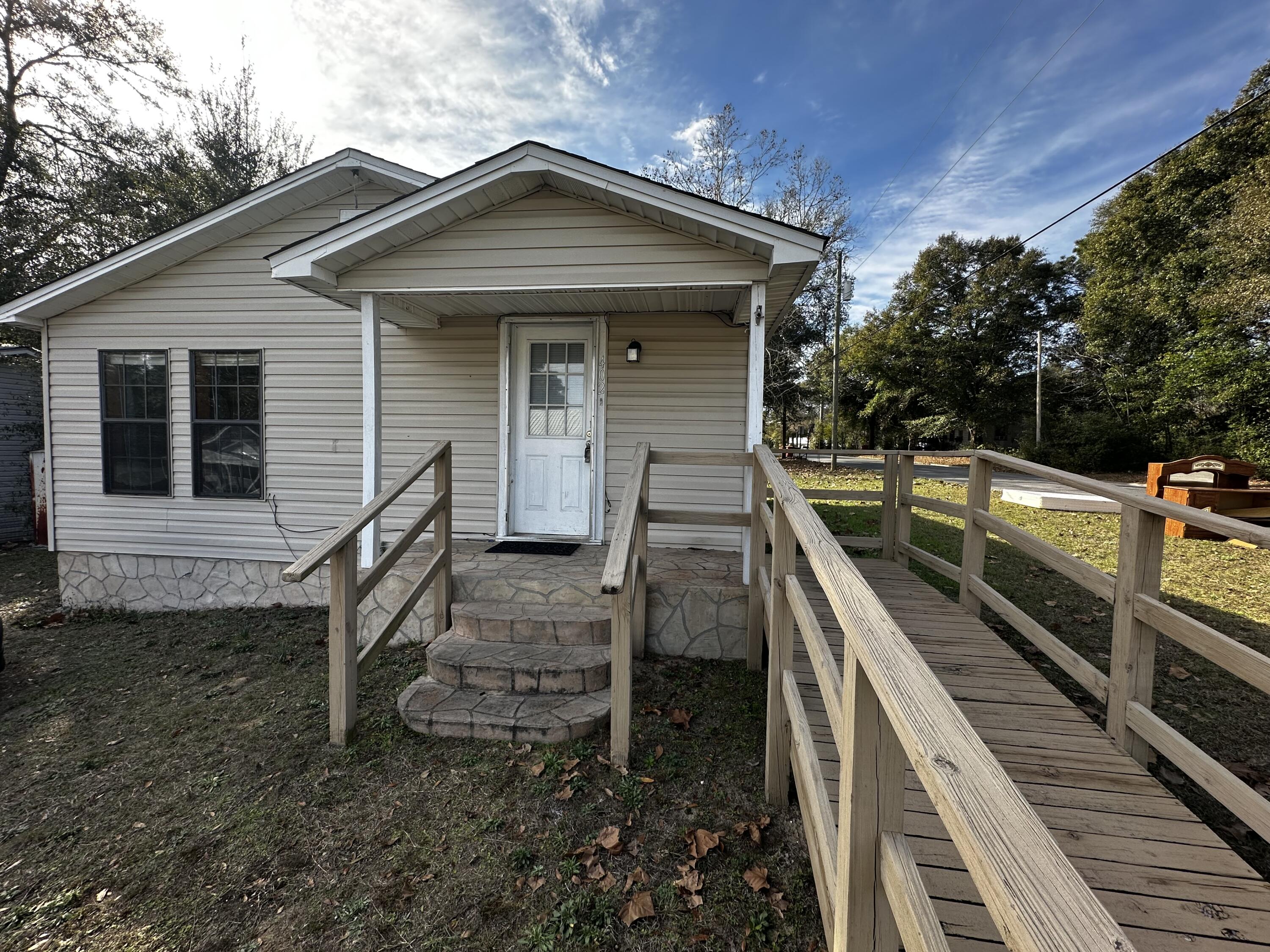 a front view of a house with wooden fence