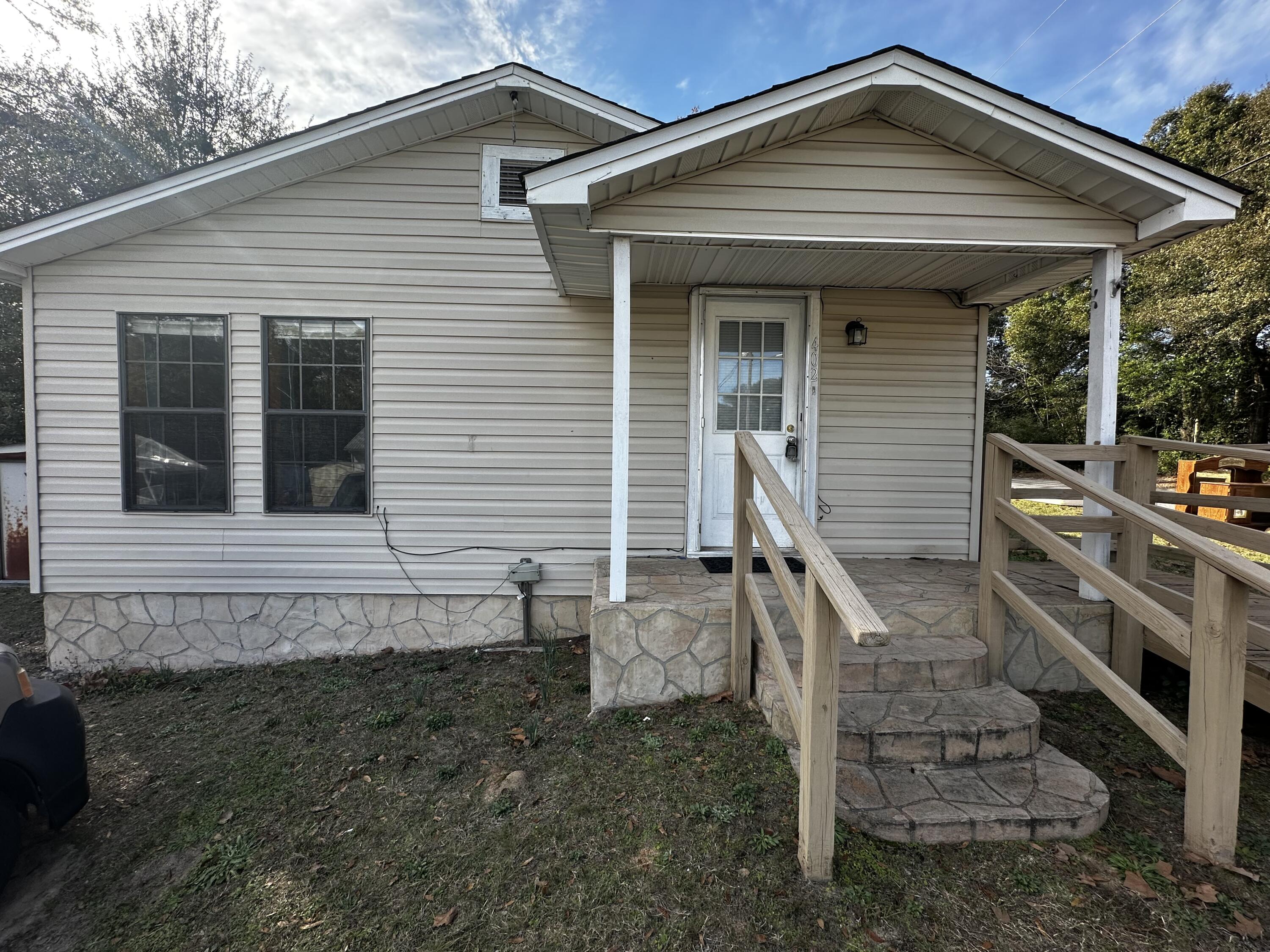 402 Church Street Crestview, FL 32539 - Photo 2 of 18 a front view of a house with stairs