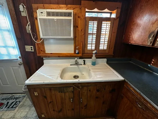 a kitchen with refrigerator and chairs