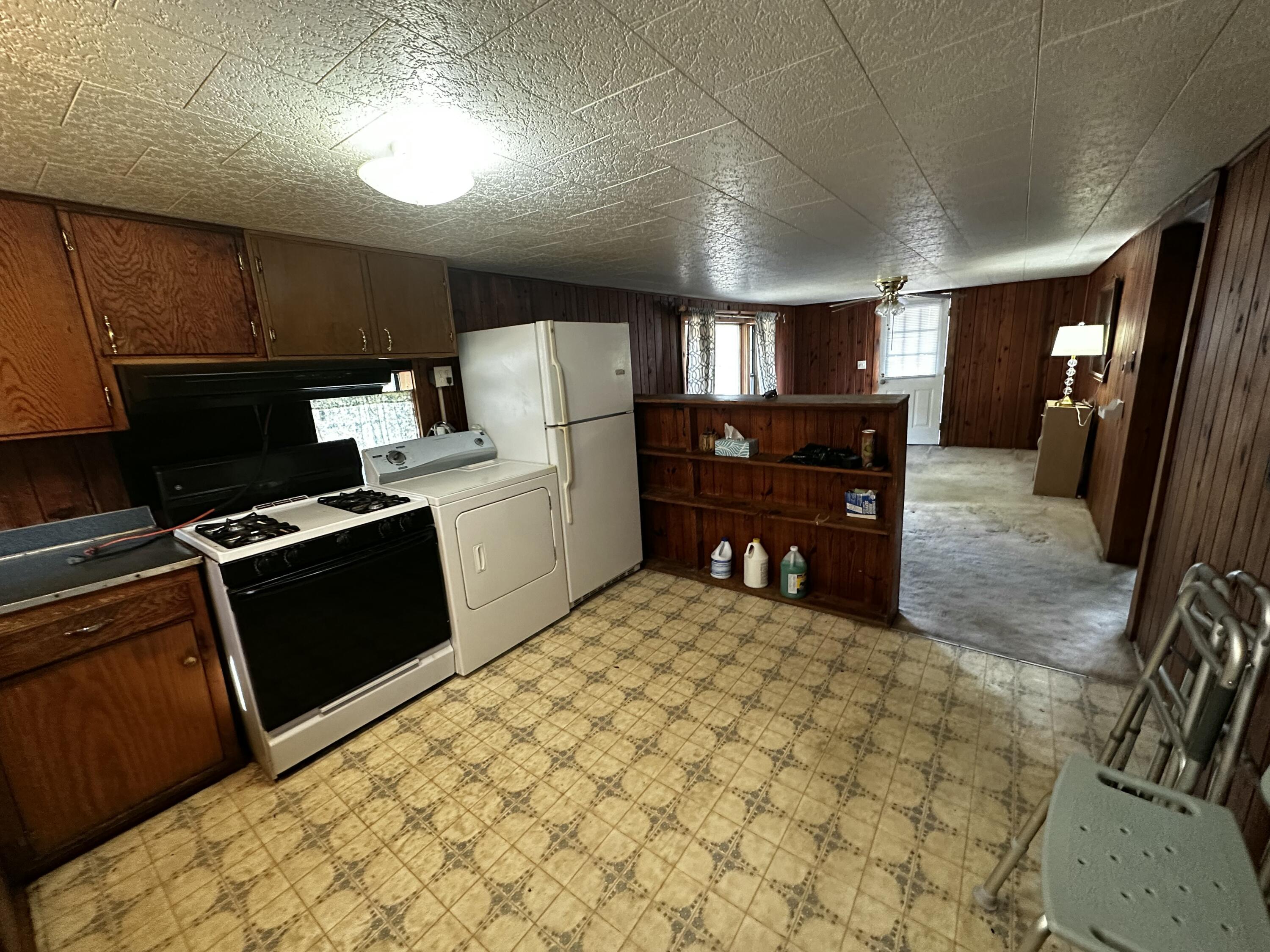 402 Church Street Crestview, FL 32539 - Photo 8 of 18 a kitchen with refrigerator and chairs