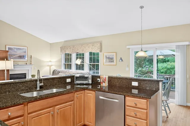 a kitchen with granite countertop a sink and a counter top space