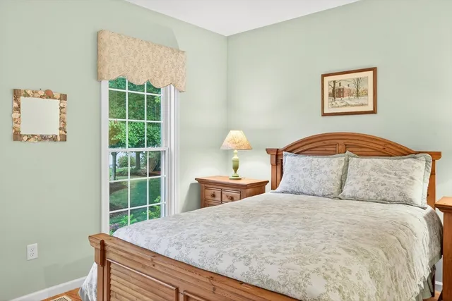 a bedroom with a large bed and a window