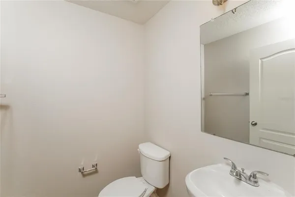 a white toilet sitting next to a bathroom sink