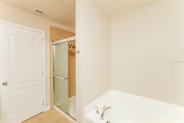 a bathroom with a tub and shower