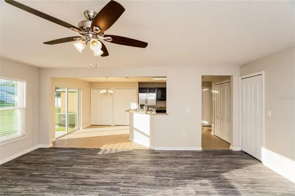 a view of a livingroom with a window and a kitchen