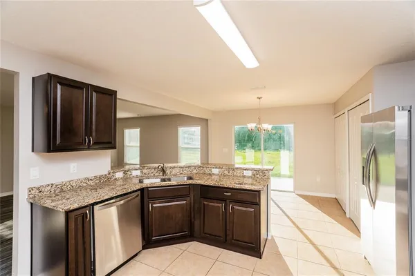 a kitchen with granite countertop a sink and a stove