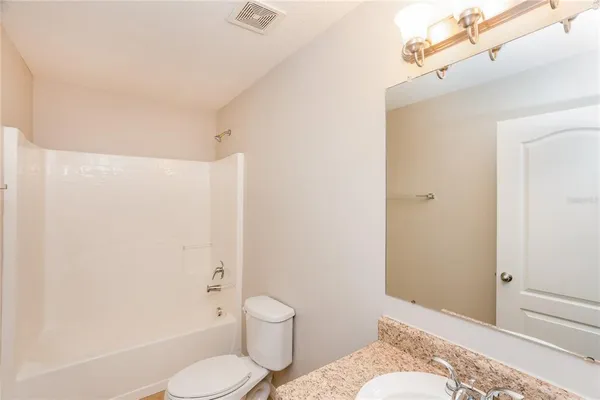 a bathroom with a toilet and shower