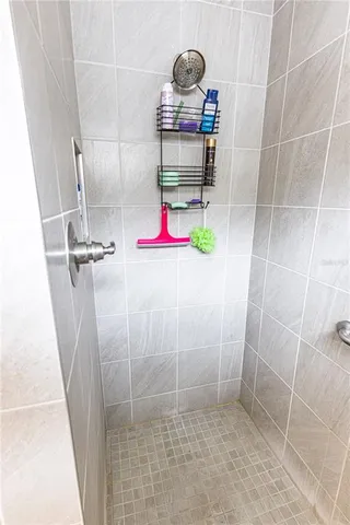 a spacious bedroom with a bed and a chandelier