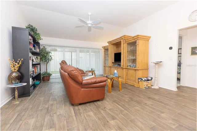 a view of a dining room with furniture a chandelier and wooden floor