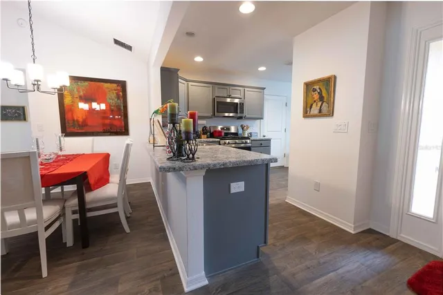a kitchen with stainless steel appliances granite countertop a refrigerator and a sink