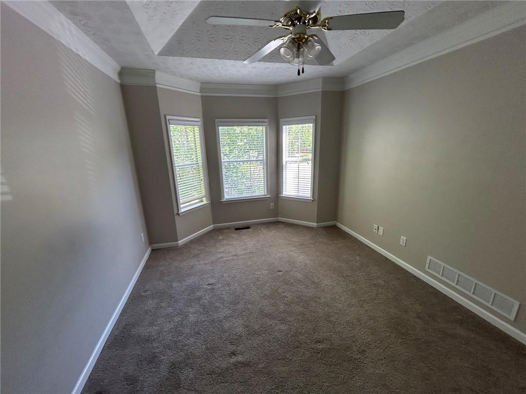 95 Luke Drive Dallas, GA 30132 - Photo 9 of 15 en empty room with windows and chandelier fan