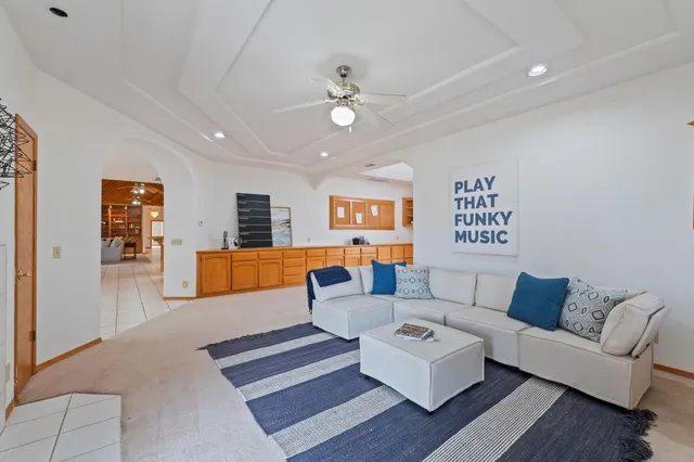 a spacious bathroom with a double vanity sink a large mirror and a bathtub