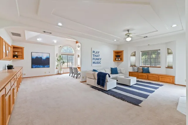 a living room with kitchen island furniture and a window