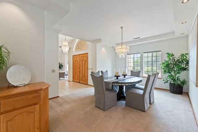 a view of a kitchen with kitchen island a sink a counter top space and stainless steel appliances