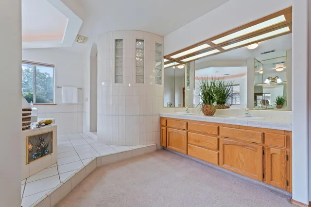 a bathroom with a granite countertop sink and a mirror