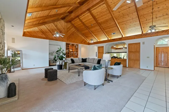 a dining room with furniture and a floor to ceiling window