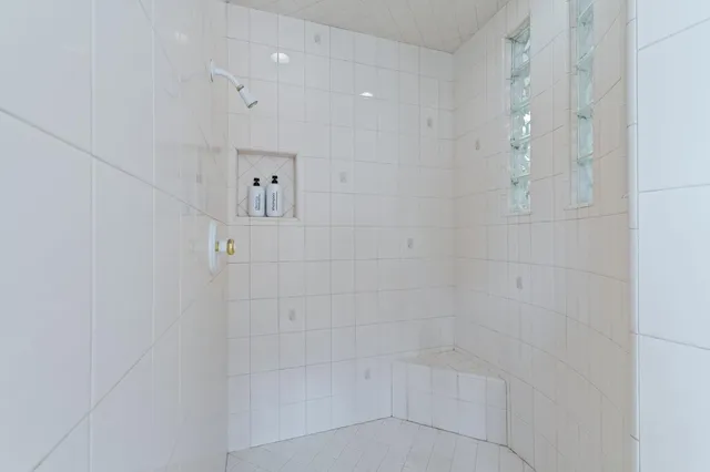 a view of a room with a ceiling fan and a window