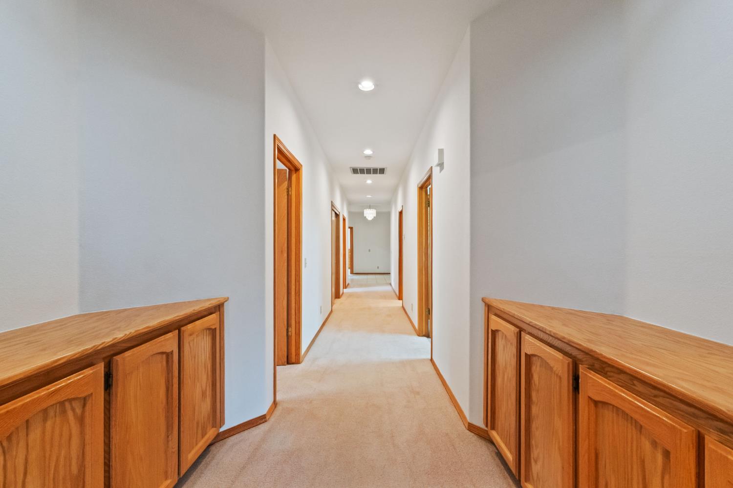 7357 East Dennett Avenue Fresno, CA 93737 - Photo 36 of 84 a view of a hallway with wooden floor